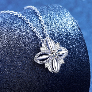 S925 sterling silver clover necklace with moissanite accents on a dark blue background
