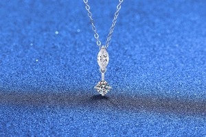 Macro shot of S925 sterling silver necklace featuring marquise and round cut moissanite