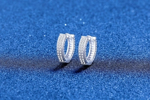 Macro view of S925 sterling silver hoop earrings with triple row pave moissanite detail