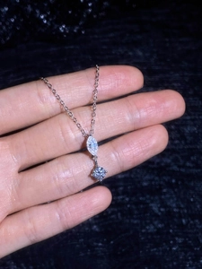 Detail of S925 silver necklace with marquise and round cut moissanite pendant
