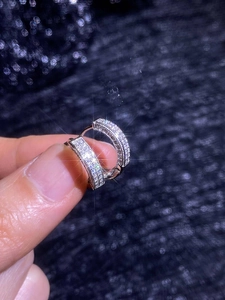 Close-up of S925 sterling silver huggie earrings with full pave cubic zirconia detail