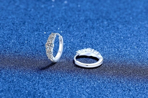 Macro view of S925 sterling silver huggie earrings with five brilliant Moissanite stones