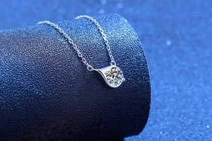 Macro detail of S925 silver moissanite pendant with a classic water drop bezel design