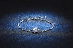 Macro detail of six-prong moissanite setting on a 925 sterling silver chain bracelet
