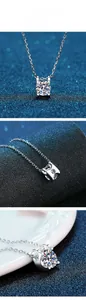 Detailed close-up of Moissanite pendant with classic four-prong setting and silver chain
