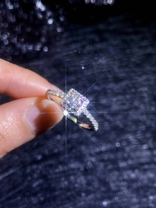 Macro shot of princess cut moissanite ring showing 925 silver pave setting details