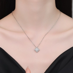 Elegant S925 sterling silver clover necklace with shimmering moissanite pendant on a model