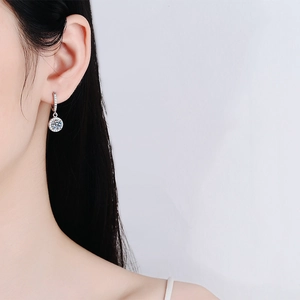 Classic S925 sterling silver moissanite drop earrings worn by a model in a close-up