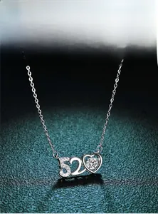 Macro detail of 520 heart pendant necklace featuring sparkling pavé crystals and O-chain