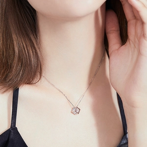 Elegant S925 silver necklace with a 1-carat moissanite cube pendant on a female model