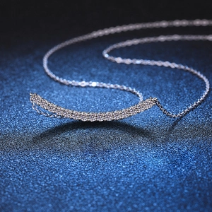 Minimalist S925 sterling silver moissanite smile curved necklace on a dark blue background