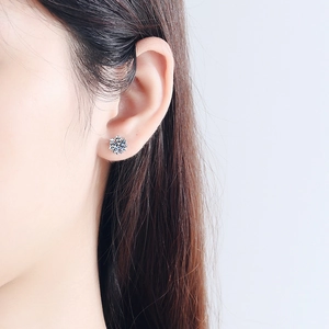 Classic snowflake moissanite stud earring in S925 silver on a female model side profile