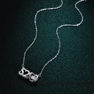 Macro detail of 925 silver 520 heart pendant with a dancing moissanite stone center