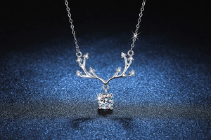 Macro shot of silver deer antler pendant with sparkling moissanite on starry background