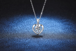Close-up of heart-shaped S925 silver pendant featuring a central round moissanite stone