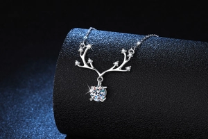 Detail of s925 silver deer antler pendant with a large round moissanite on a display stand