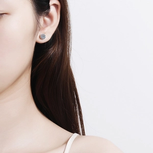 Elegant 925 sterling silver moissanite flower stud earrings worn by a model for daily wear