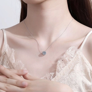 Collier marguerite en argent 925 avec pendentif moissanite 1 carat sur le cou d'un modèle