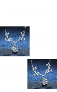 Macro shot of silver deer antler necklace pendant featuring a brilliant moissanite stone
