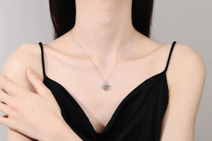 Detailed close-up of S925 sterling silver heart pendant with sparkling moissanite stone