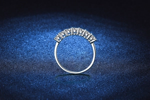 Macro shot of 925 silver seven-stone moissanite ring with claw setting on blue background