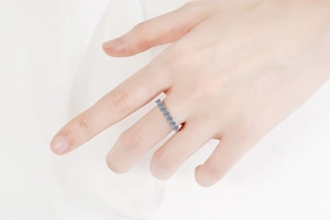Close-up of S925 sterling silver eternity ring with sparkling Moissanite stones on finger