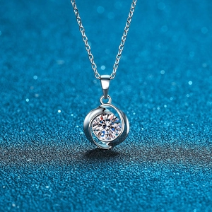 Macro view of sterling silver necklace featuring a swirling lucky clover moissanite pendant