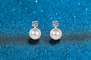 Macro shot of S925 sterling silver pearl earrings with sparkling moissanite stones
