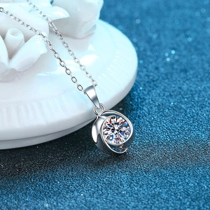 Macro view of a brilliant round moissanite pendant with swirling S925 silver setting
