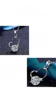 Detail eines herzförmigen Moissanit-Anhängers mit Love-Gravur an einer silbernen Kette