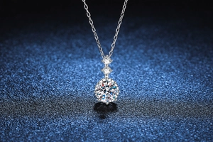 Detail of s925 silver moissanite necklace with triple-stone vertical pendant setting