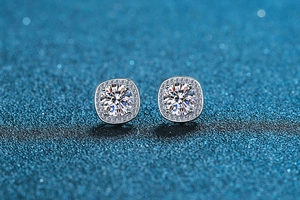 Macro detail of s925 silver stud earrings with princess square halo and moissanite stone