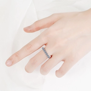 Elegant 925 sterling silver moissanite eternity ring featuring blue stones on model