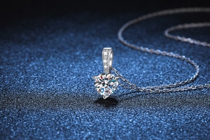 Macro detail of a 1 carat round cut moissanite pendant with triple claw setting
