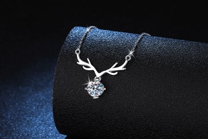 Detailed close-up of s925 silver reindeer antler pendant with sparkling moissanite stone