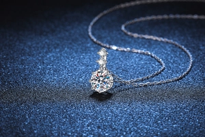 Close-up of a brilliant round moissanite pendant on a silver S925 necklace chain