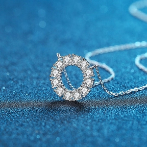 Collier en argent S925 avec pendentif rond en moissanite sur fond bleu étincelant