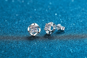 Macro shot of S925 sterling silver four-leaf clover stud earrings with moissanite stones