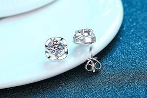 Macro shot of S925 silver four-leaf clover stud earrings with sparkling moissanite stones