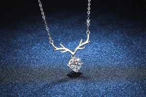 Macro shot of 925 sterling silver reindeer necklace with a brilliant moissanite stone
