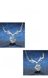 Detail of s925 silver deer horn necklace with polished finish and moissanite stone
