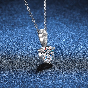 Elegant S925 sterling silver necklace with three-prong 1ct moissanite pendant on blue background