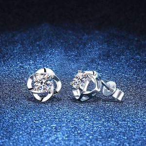 S925 sterling silver four-leaf clover moissanite stud earrings on a blue textured background