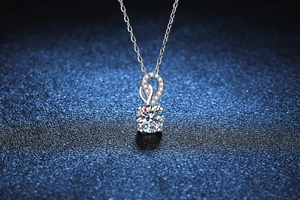 Macro shot of S925 silver necklace with 1ct moissanite pendant and spiral diamond detail