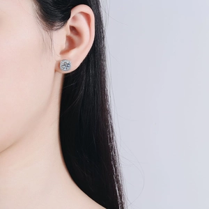 Elegant S925 sterling silver princess halo moissanite stud earrings worn by a model
