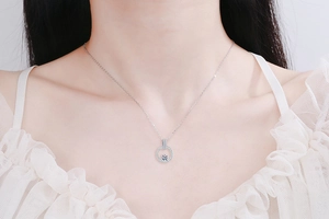 Close-up of S925 sterling silver necklace featuring a sparkling halo round moissanite pendant