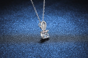 Detailed close-up of a shimmering round cut moissanite pendant on a silver chain