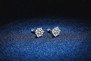 Detailed macro view of S925 silver moissanite studs with 6-prong setting and screw back
