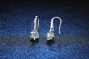 Macro shot of 925 silver snowflake earrings featuring 0.5ct moissanite and claw setting