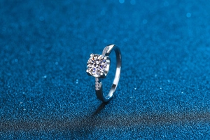 Macro side view of moissanite ring showing 4-prong setting and side accent stones